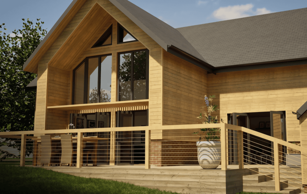 A 3D architectural rendering of a modern, timber-clad house with a steep pitched roof and dark shingles. The home features large windows, including a triangular window under the main gable, and a raised wooden deck with a wire railing. A patio dining set and a large potted plant are situated on the deck.