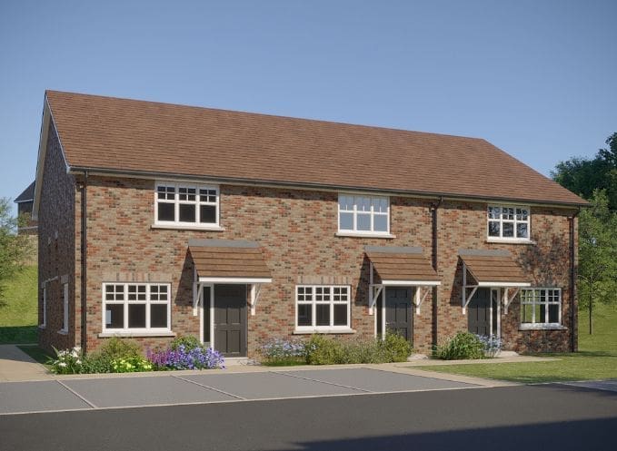A brick townhouse under a clear blue sky at Highwood Grove, featuring sustainable timber frame Isle of Wight construction.
