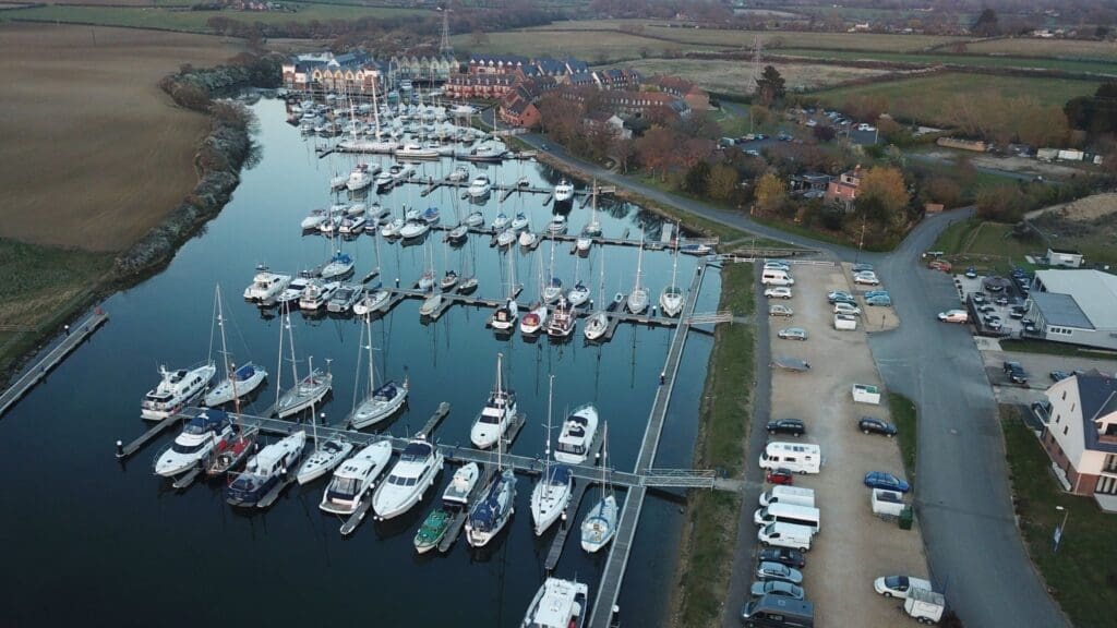Aerial view of Island Harbour Marina with sailboats, featuring precision timber frames for waterfront timber construction.